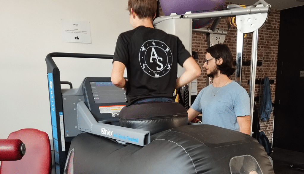 Photo montrant un jeune de dos en train d'effectuer une séance sur l'Alter-G.